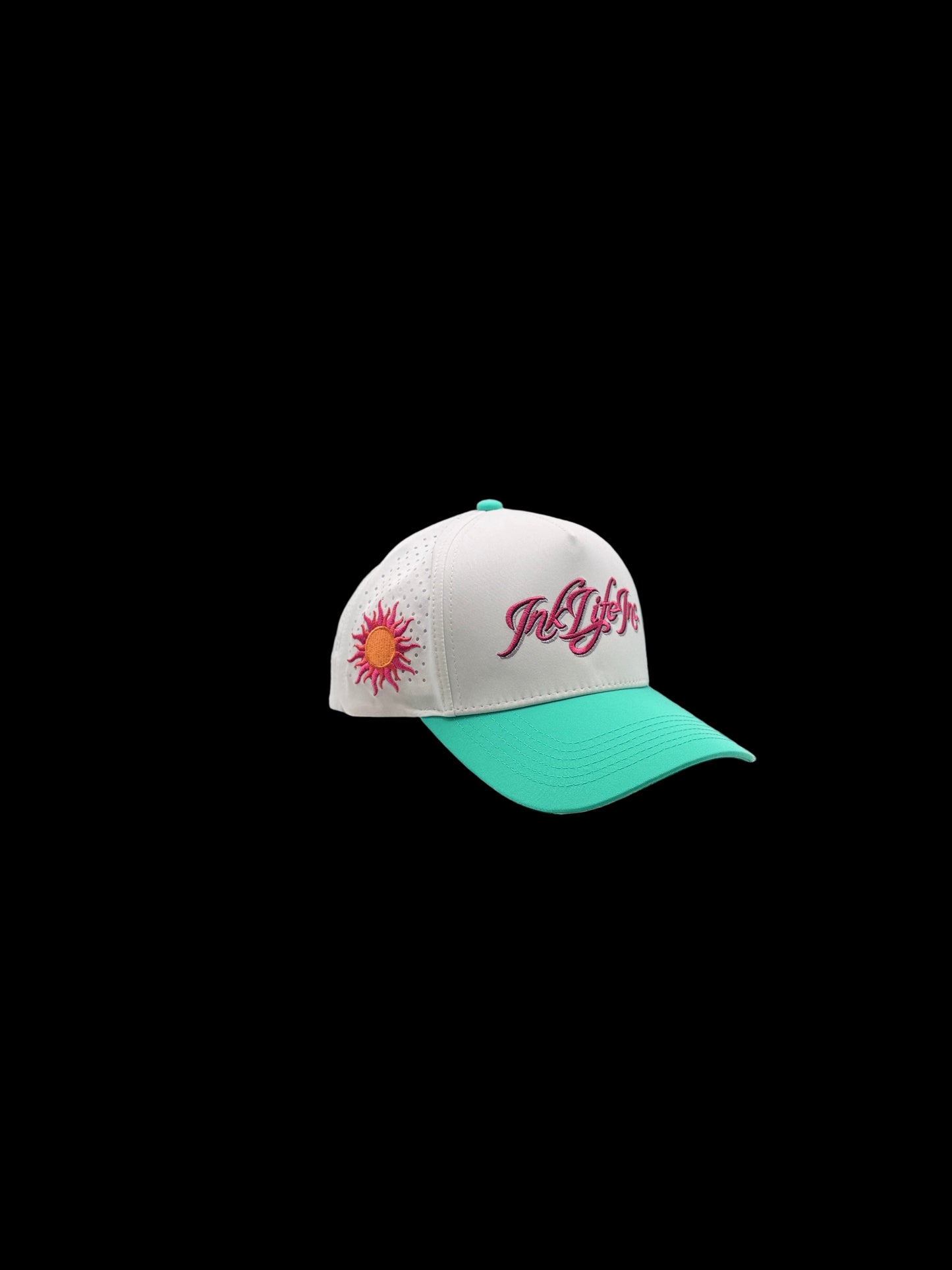 White and teal cap with a logo inside a photography light tent.